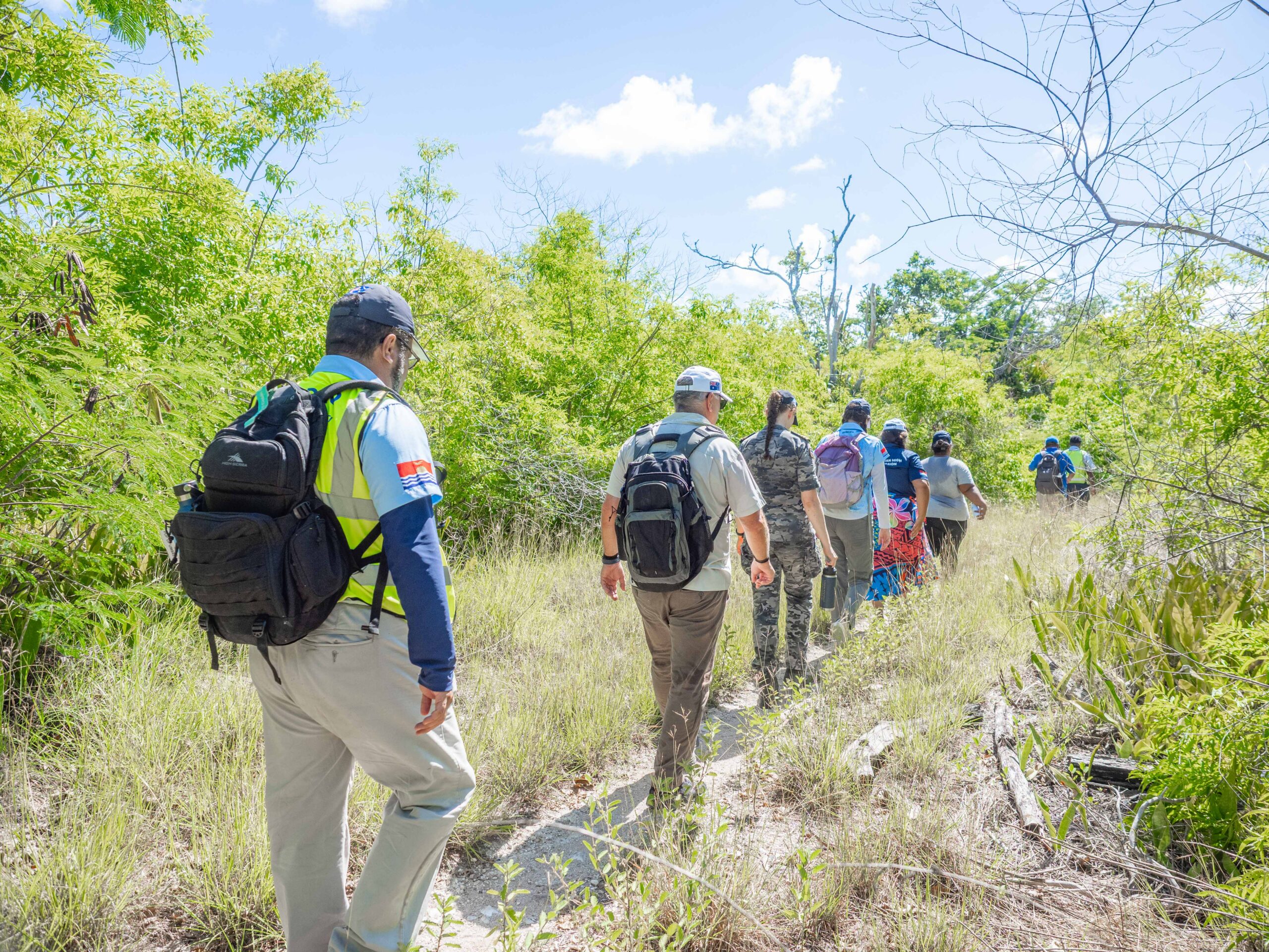 Anthony (left) walking through Banaba Island with local and international humanitarian partners. Image credit: Lieutenant Commander BJ Glover.